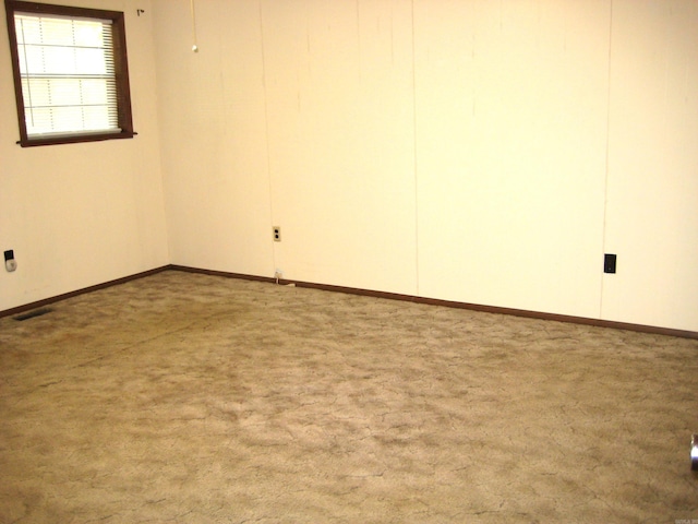 901 Hastey Ave, Mena, AR 71953 - spare room with visible vents, carpet floors, and baseboards