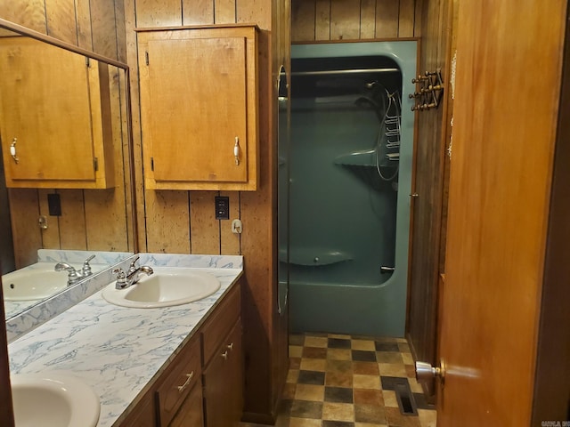901 Hastey Ave, Mena, AR 71953 - full bathroom featuring double vanity, wood walls, and a sink