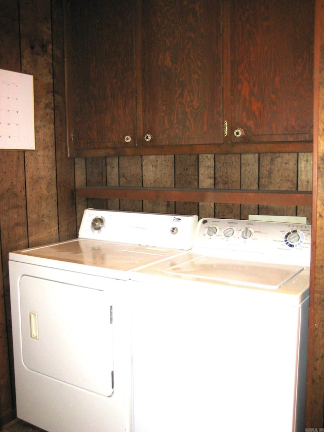 901 Hastey Ave, Mena, AR 71953 - clothes washing area featuring cabinet space and separate washer and dryer