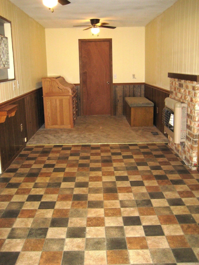 901 Hastey Ave, Mena, AR 71953 - interior space with carpet, ceiling fan, wainscoting, a fireplace, and heating unit