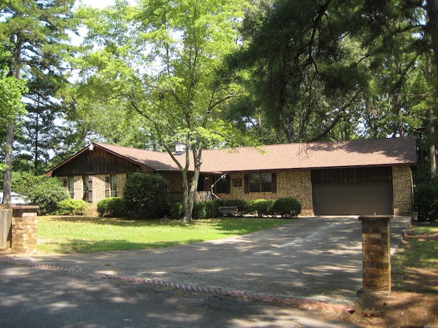 901 Hastey Ave, Mena, AR 71953 - single story home with driveway, brick siding, an attached garage, and a front lawn