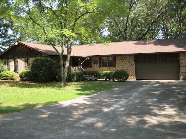 901 Hastey Ave, Mena, AR 71953 - single story home with a front yard, an attached garage, brick siding, and driveway
