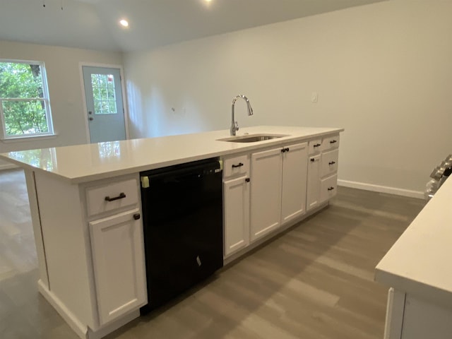 kitchen with sink, white cabinetry, a center island with sink, dishwasher, and hardwood / wood-style flooring