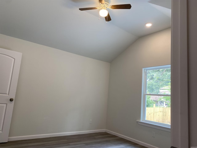 additional living space with lofted ceiling, dark hardwood / wood-style floors, and ceiling fan