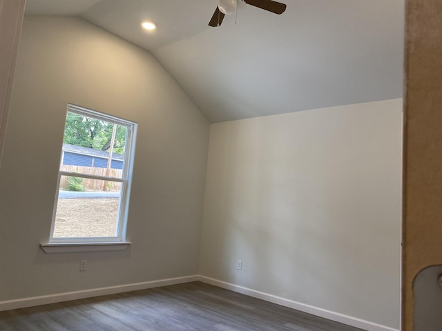 additional living space with ceiling fan, lofted ceiling, and dark hardwood / wood-style flooring