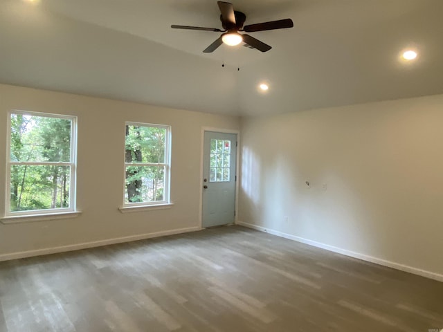 spare room with ceiling fan, lofted ceiling, and wood-type flooring