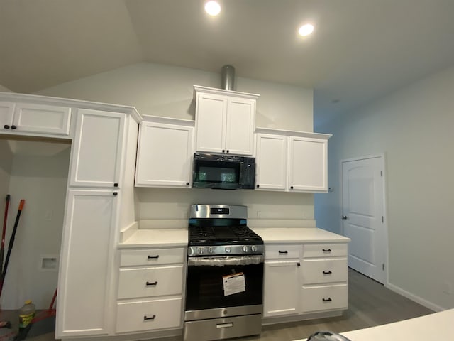 kitchen with white cabinetry, stainless steel range with gas stovetop, vaulted ceiling, and dark wood-type flooring