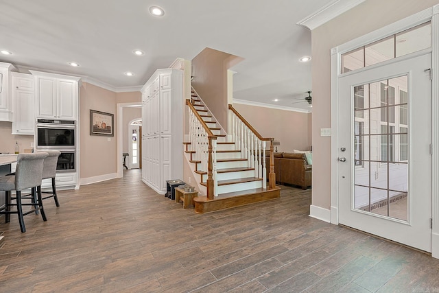 entrance foyer featuring ceiling fan, crown molding, and dark hardwood / wood-style flooring