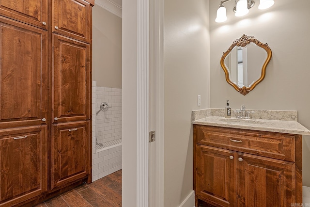 bathroom with ornamental molding, vanity, and hardwood / wood-style flooring