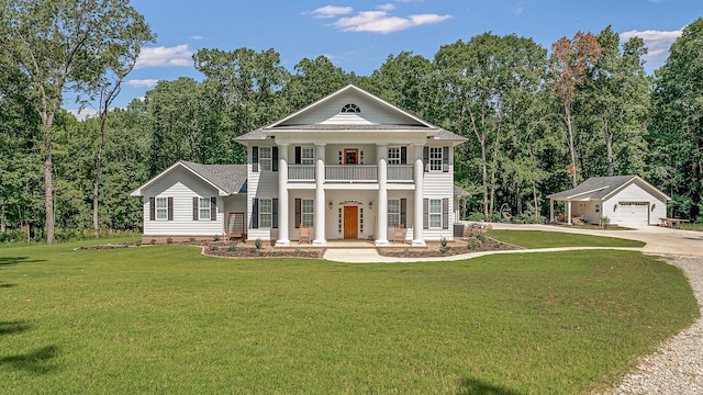 neoclassical home with a balcony, a garage, an outdoor structure, and a front yard