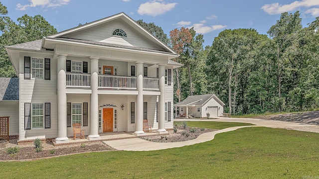 neoclassical / greek revival house with an outdoor structure, a balcony, and a front yard