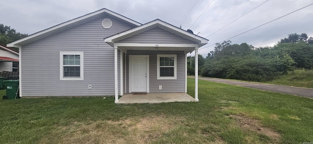 rear view of property with a lawn