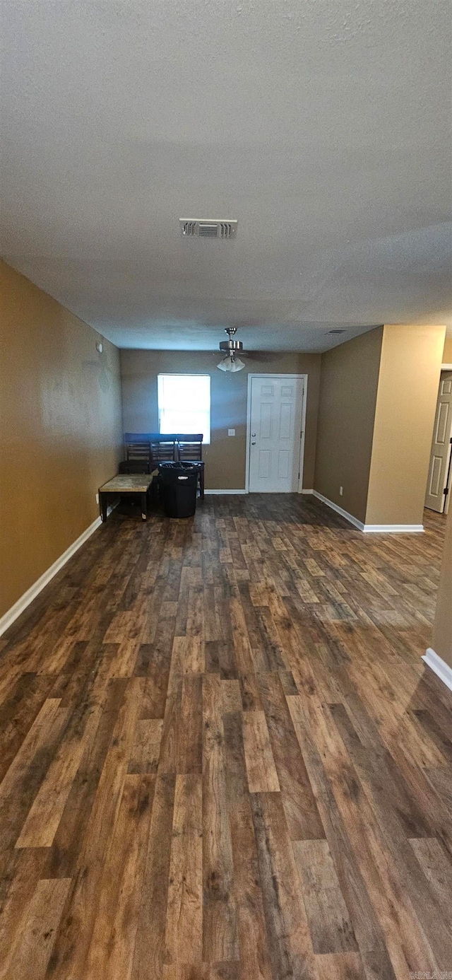 unfurnished living room with a textured ceiling, hardwood / wood-style flooring, and ceiling fan