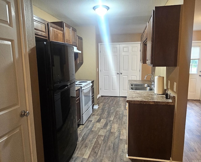 kitchen featuring sink, black fridge, exhaust hood, white range oven, and dark hardwood / wood-style floors