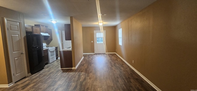 kitchen with dark wood-type flooring, black refrigerator, and white electric range oven