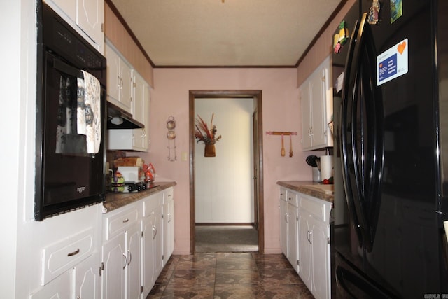 kitchen featuring black appliances, white cabinets, under cabinet range hood, and crown molding