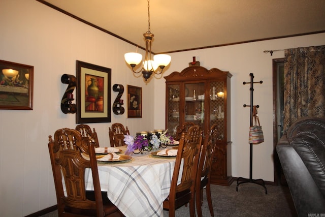 dining space featuring a chandelier, carpet floors, and crown molding