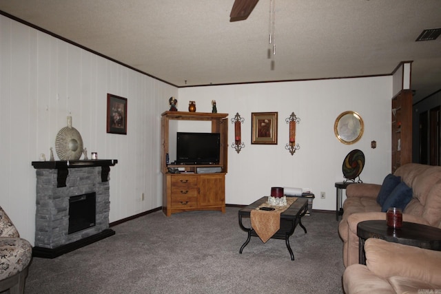 living room with a stone fireplace, dark carpet, and a textured ceiling