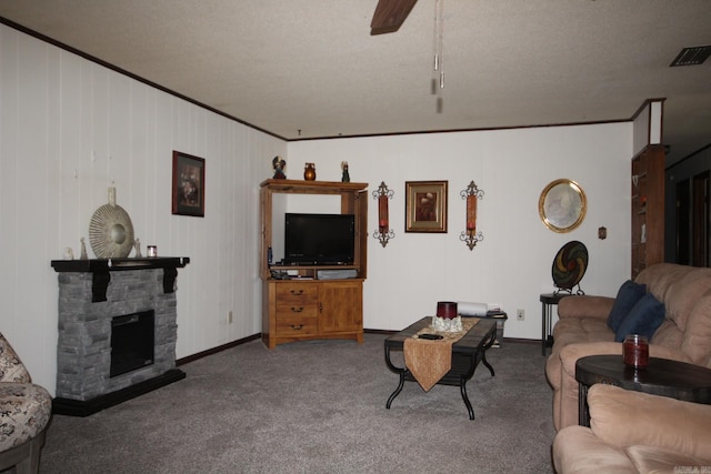 living room with carpet, crown molding, baseboards, a fireplace, and ceiling fan
