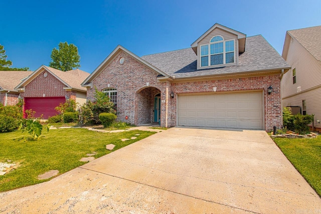 view of front of home with a garage and a front lawn