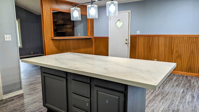 kitchen featuring dark wood-type flooring, decorative light fixtures, a center island, and gray cabinetry