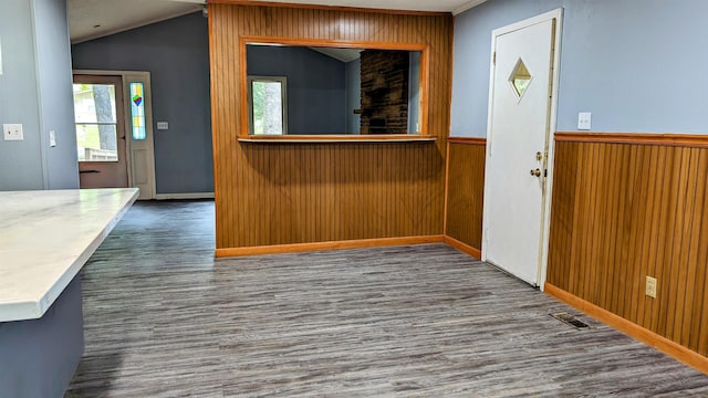 interior space featuring dark hardwood / wood-style flooring and vaulted ceiling