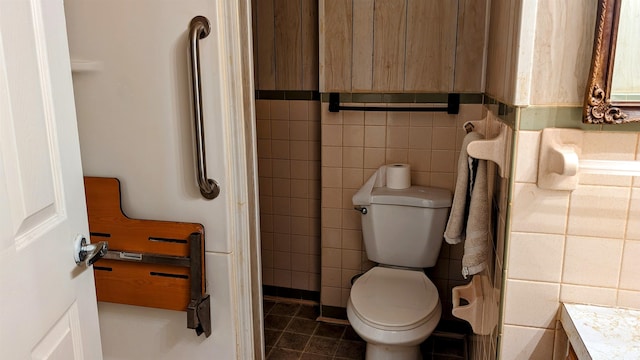 bathroom with vanity, tile patterned floors, tile walls, and toilet