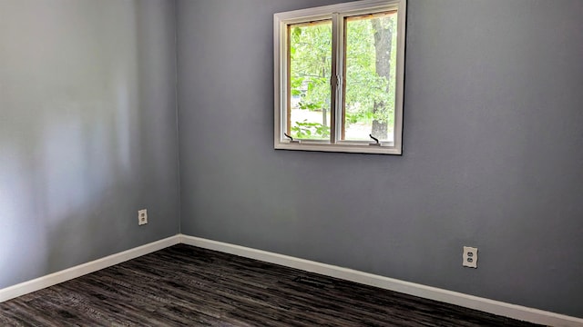 spare room with dark hardwood / wood-style flooring