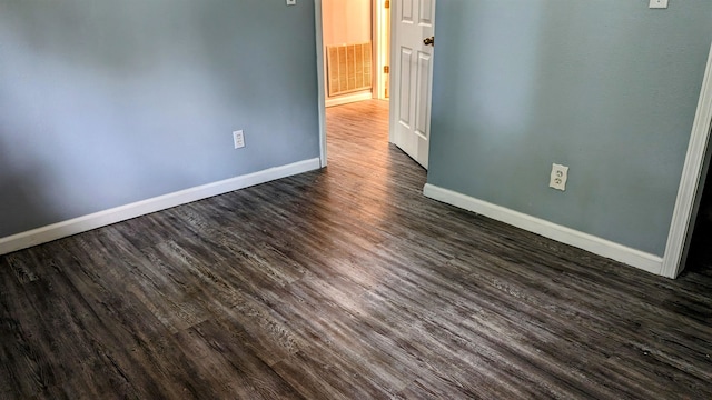 unfurnished room with dark hardwood / wood-style floors