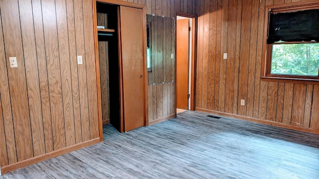 interior space featuring wood walls and hardwood / wood-style floors