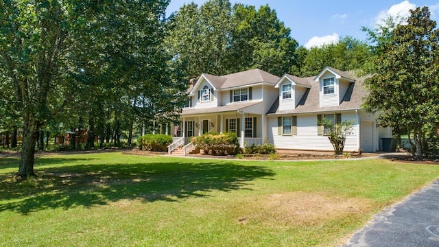 view of front of property featuring a front lawn, a porch, and a garage