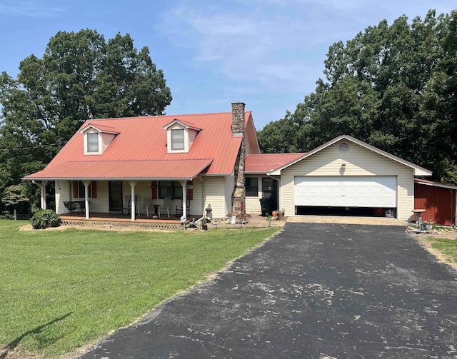 view of front of property featuring a garage, a front yard, and covered porch