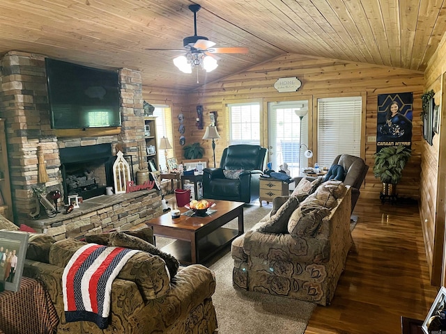 living room featuring lofted ceiling, wood walls, wood ceiling, hardwood / wood-style floors, and a fireplace