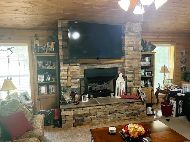 living room featuring wood walls, a fireplace, wooden ceiling, and hardwood / wood-style floors