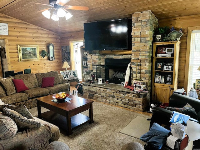 living room featuring a stone fireplace, vaulted ceiling, wood ceiling, and ceiling fan