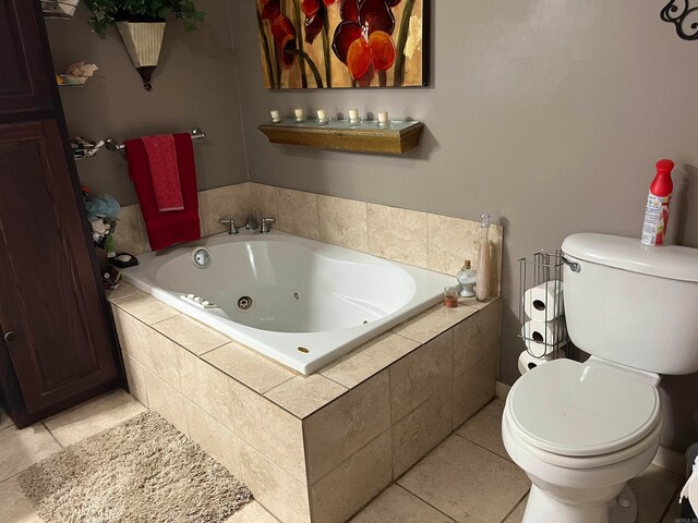 bathroom featuring toilet, tile patterned flooring, and a relaxing tiled tub