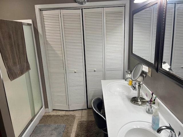 bathroom with dual vanity and tile patterned floors