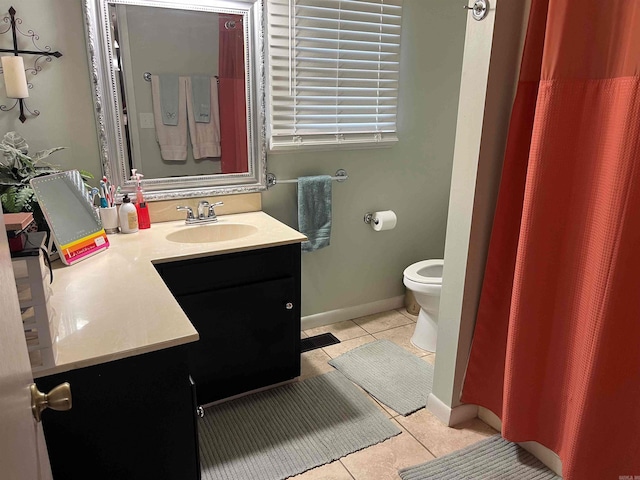 bathroom with vanity, toilet, and tile patterned flooring