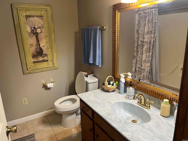 bathroom featuring tile patterned floors, toilet, and vanity