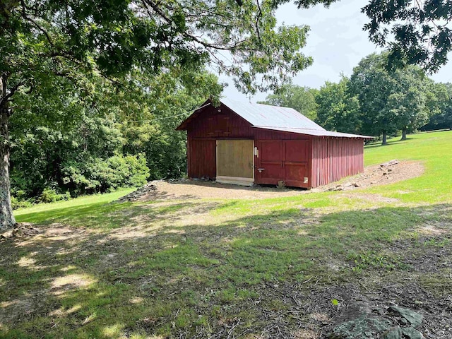 view of outbuilding featuring a yard