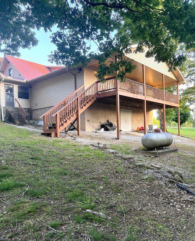 view of side of home featuring a yard and a wooden deck