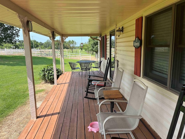 wooden deck with a lawn