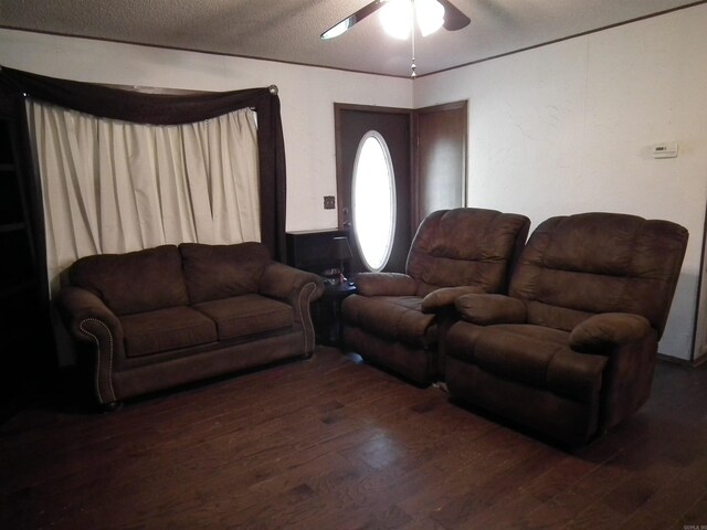 living room with wood finished floors, ceiling fan, and a textured ceiling