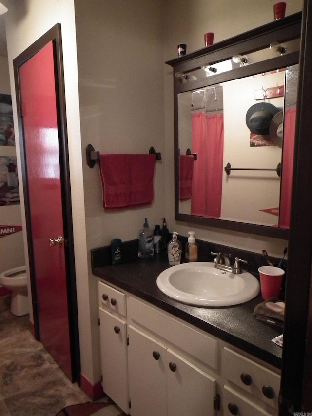 bathroom featuring vanity, toilet, and a shower with curtain