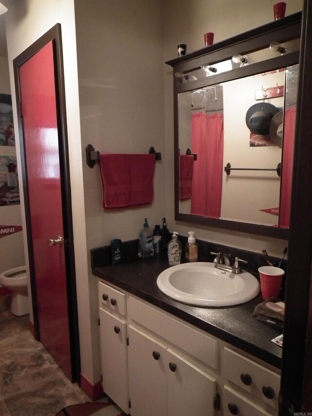 bathroom featuring toilet and vanity