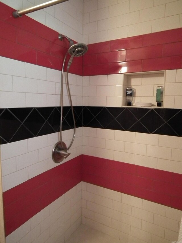 bathroom with tiled shower
