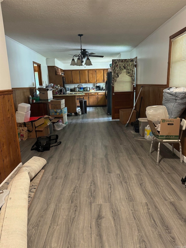 interior space featuring ceiling fan, a textured ceiling, and hardwood / wood-style flooring