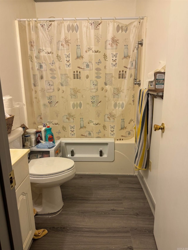 full bathroom with vanity, toilet, wood-type flooring, and shower / tub combo