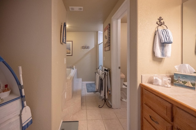 bathroom with vanity, tile patterned floors, and a bathing tub