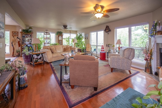 living room featuring hardwood / wood-style flooring and ceiling fan